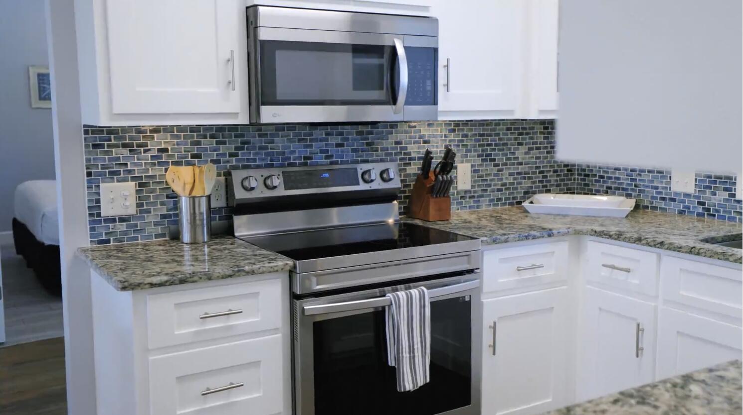 83 Sunfish Street Destin, FL 32541 - Photo 27 of 56 a kitchen with granite countertop a sink stove and cabinets