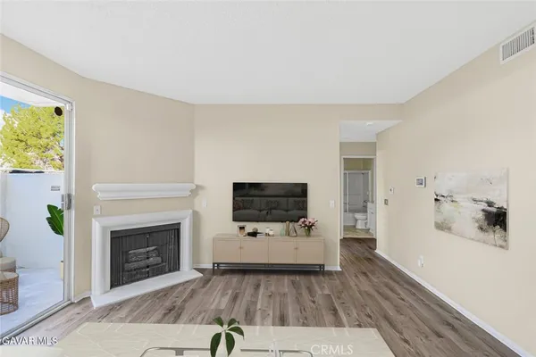 a living room with furniture and a fireplace