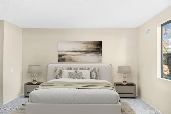 a bedroom with a bed and a night stand