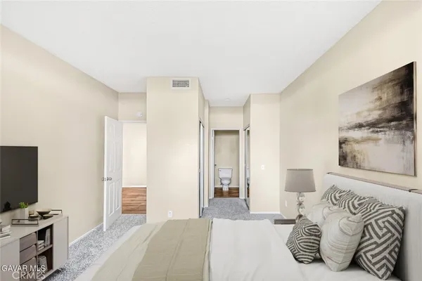 a bedroom with a bed and a television