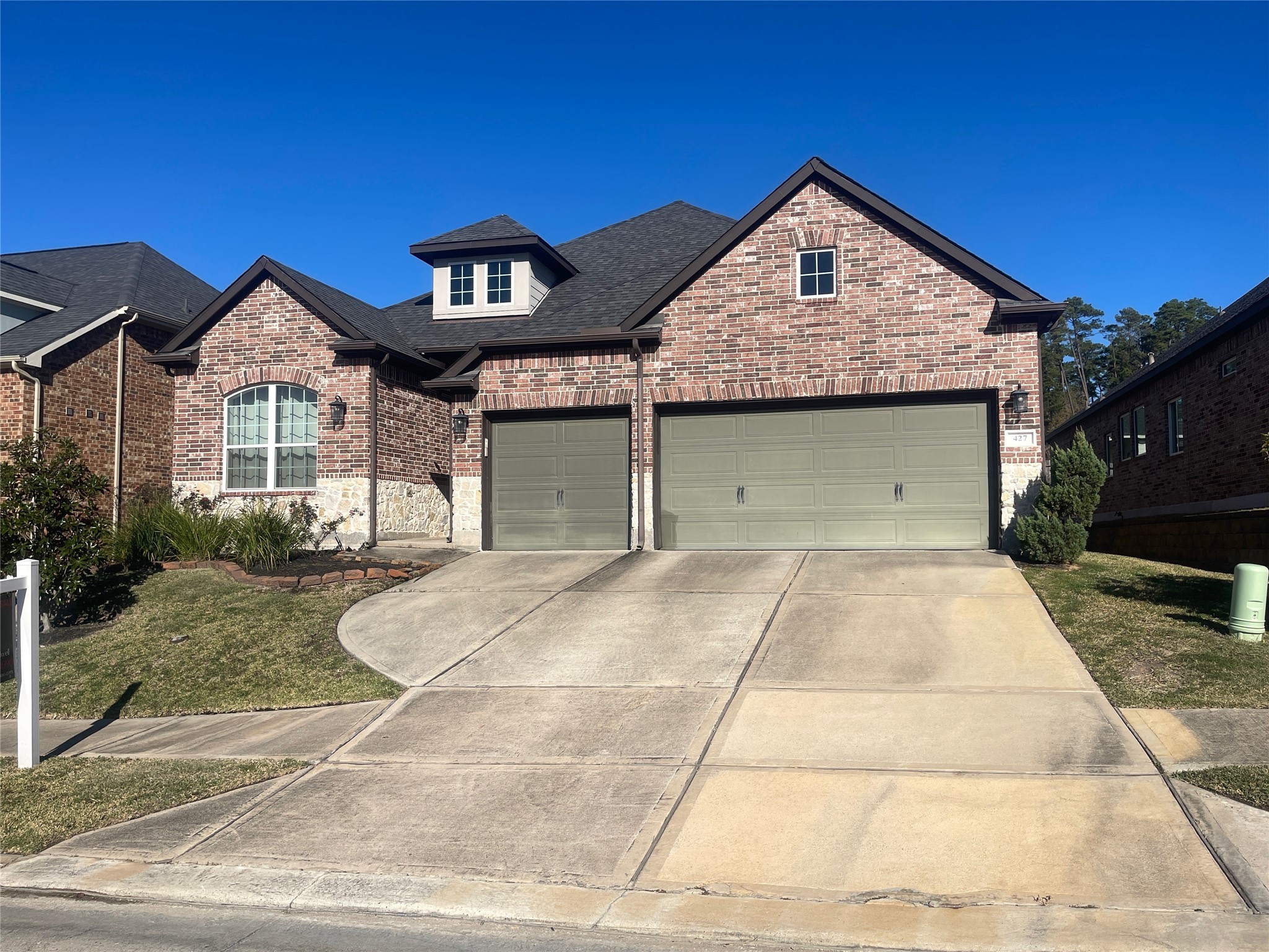 427 Stonebrook Lane Conroe, TX 77304 - Photo 2 of 15 a front view of a house with a yard and garage
