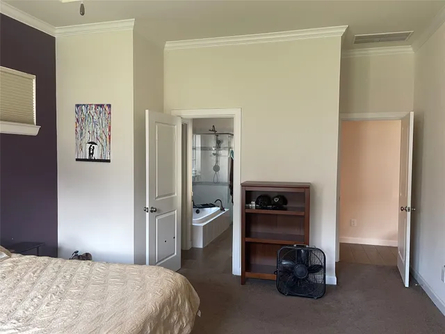 a bedroom with a bed and a view of bathroom