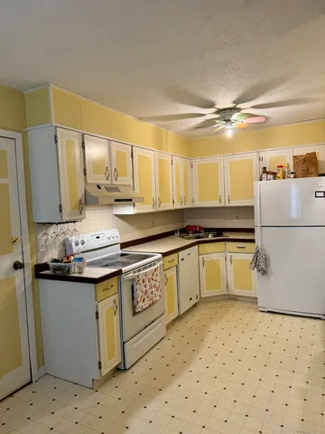 a kitchen with a sink a stove and refrigerator