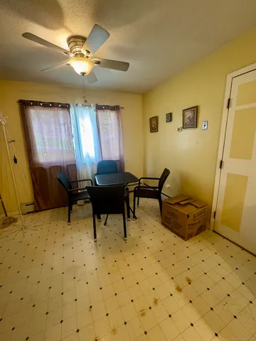 a living room with a chairs and a table