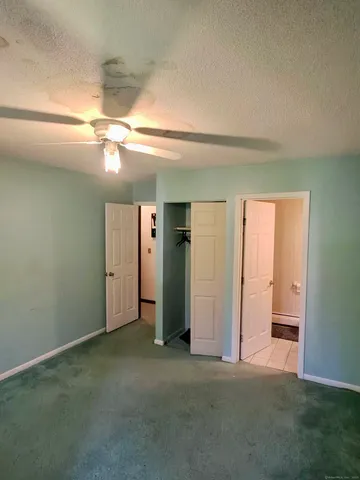 an empty room with closet and a bathroom