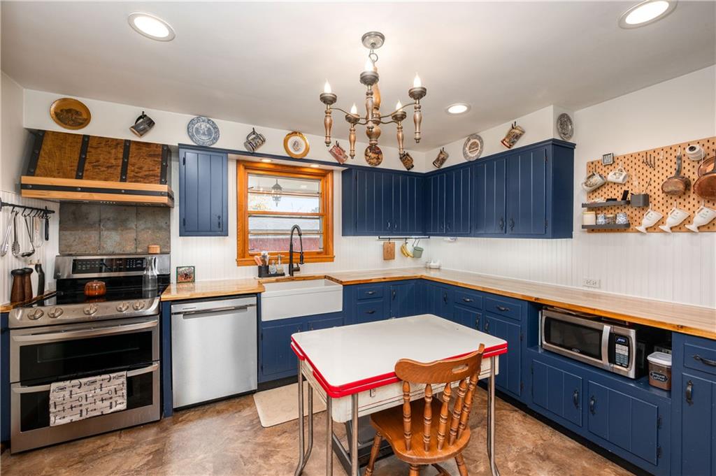 4121 Loring Street Butler, PA 16001 - Photo 8 of 37 a kitchen with stainless steel appliances granite countertop a stove a sink dishwasher and cabinets with wooden floor
