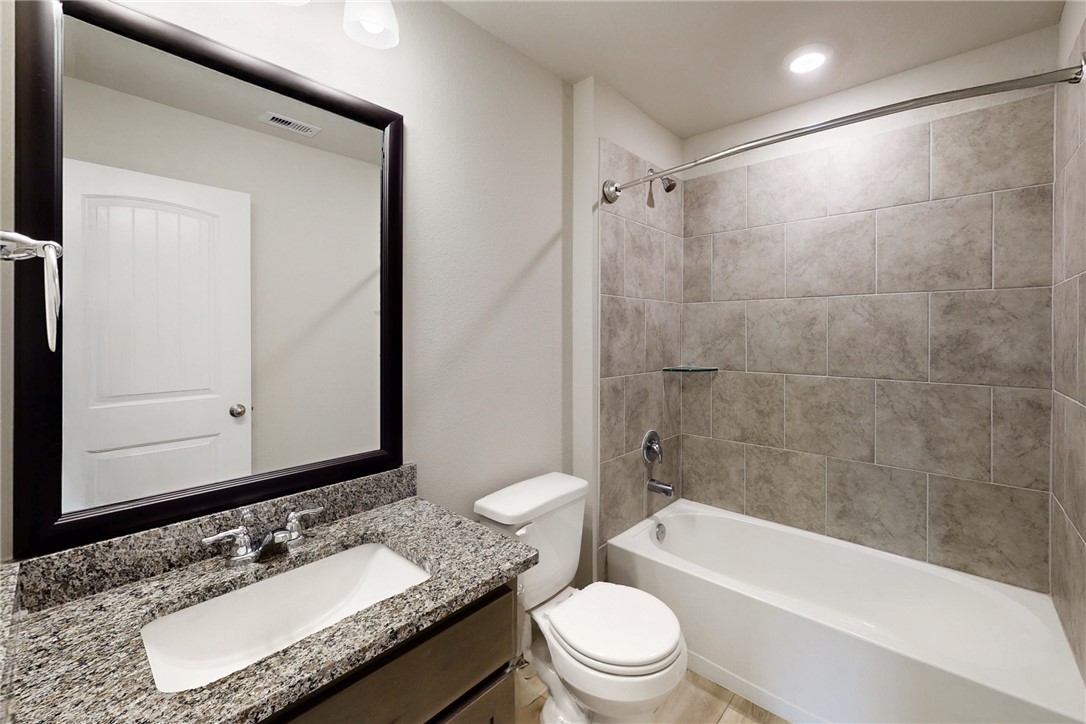 2010 Chief Street Bryan, TX 77807 - Photo 8 of 29 a bathroom with a granite countertop sink toilet mirror and shower