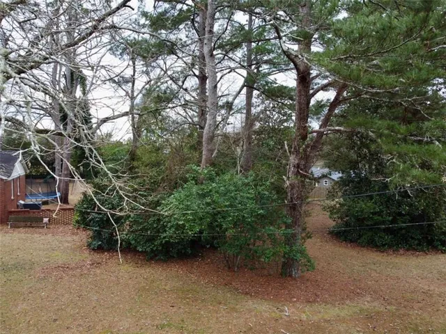 a view of a wooden fence and trees