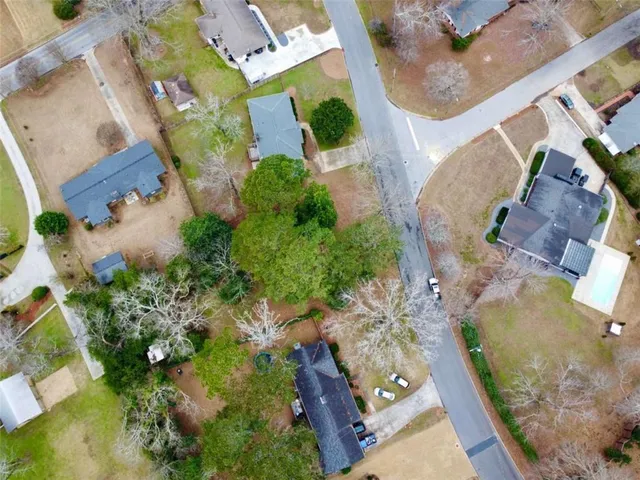 an aerial view of residential houses with outdoor space