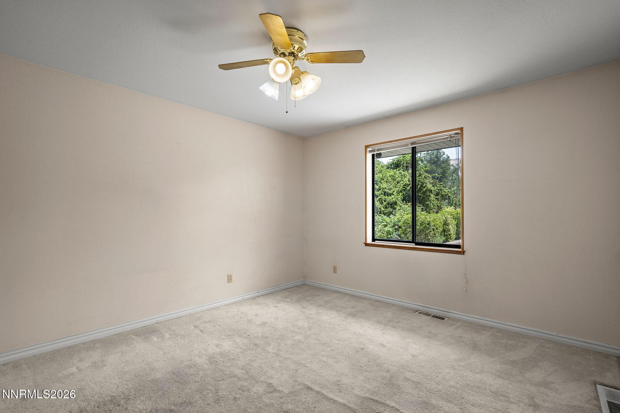 2985 Socrates Drive Reno, NV 89512 - Photo 37 of 52 an empty room with a window and a fan