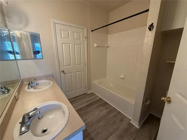 a bathroom with a tub and shower