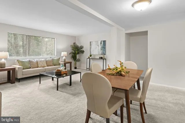 a dining room with furniture and window