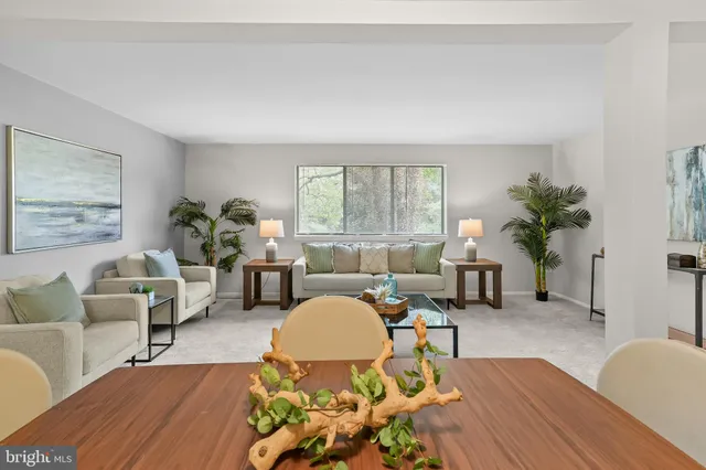 a living room with furniture fireplace and window