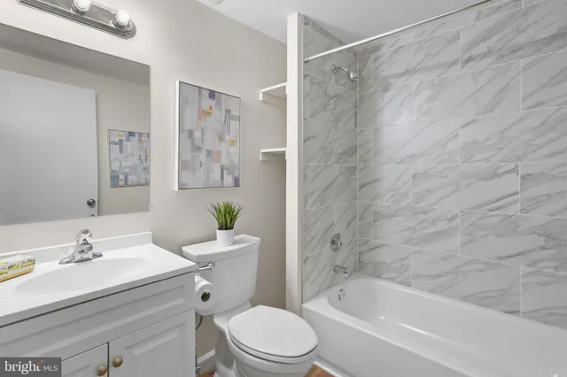 a bathroom with a sink a toilet and a bathtub