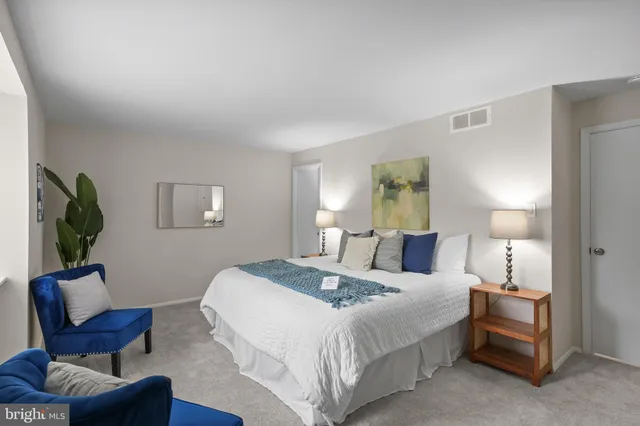 a bedroom with a bed and a chair