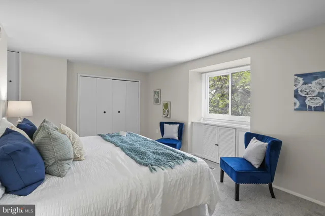 a bedroom with a bed and painting on the wall