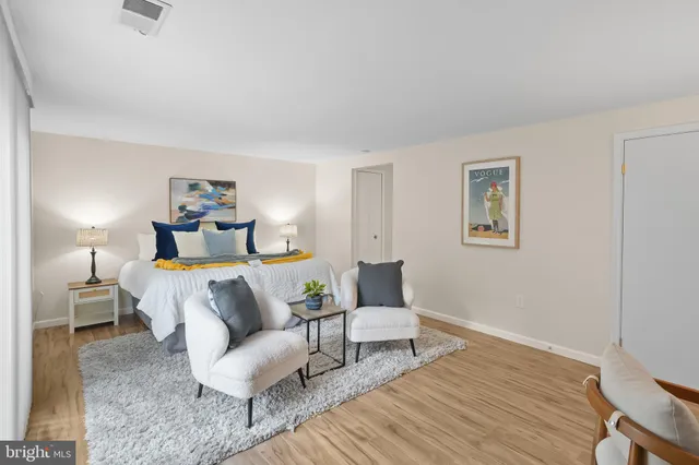 a bedroom with furniture and a wooden floor