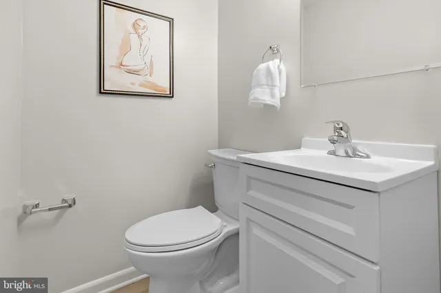 a view of a backyard with plants and wooden fence