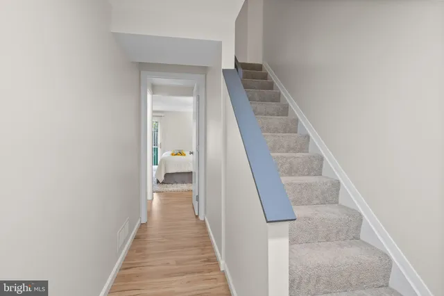 a view of a hallway with wooden floor and entryway