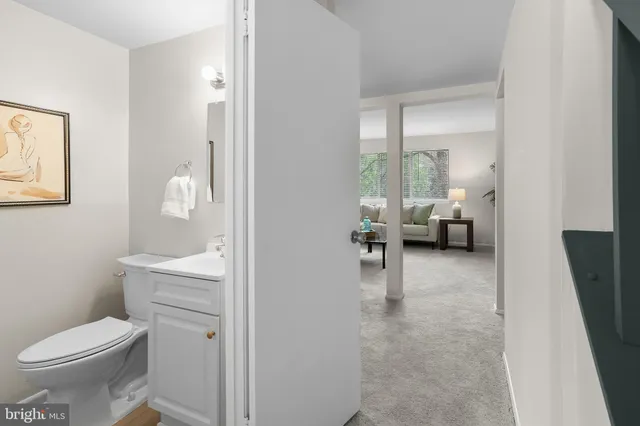 a en suite bathroom with a toilet a sink and a mirror