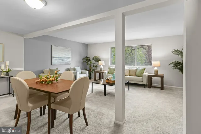 a dining room with furniture and a floor to ceiling window