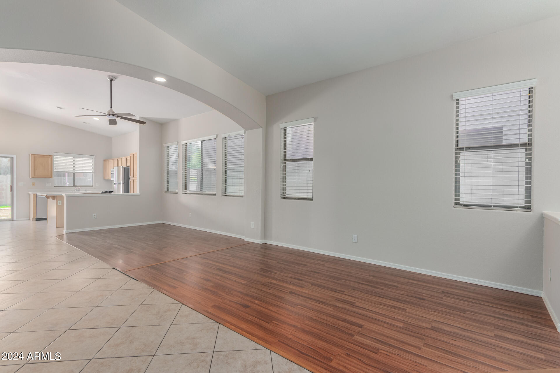 4007 East Ironhorse Road Gilbert, AZ 85297 - Photo 6 of 33 an empty room with wooden floor and windows