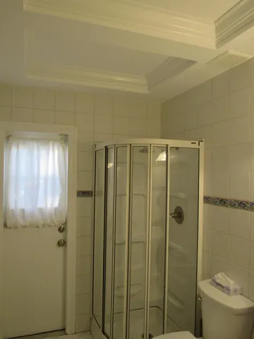 a bathroom with a shower and a toilet