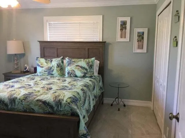 a bed sitting in a bedroom next to a window