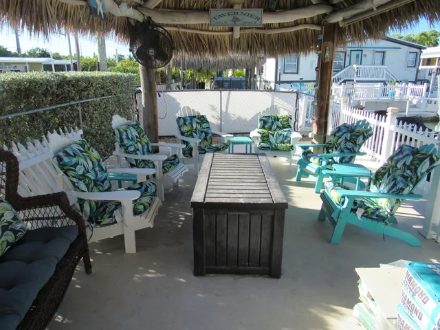 a view of a patio with table and chairs potted plants with wooden floor