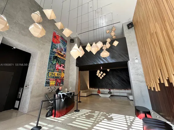 a view of a entryway with furniture and chandelier