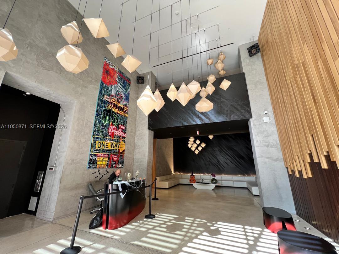 151 Southeast 1st Street, Unit 3010 Miami, FL 33131 - Photo 13 of 22 a view of a entryway with furniture and chandelier