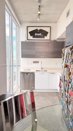 a living room with a couch and a dining table with garden view