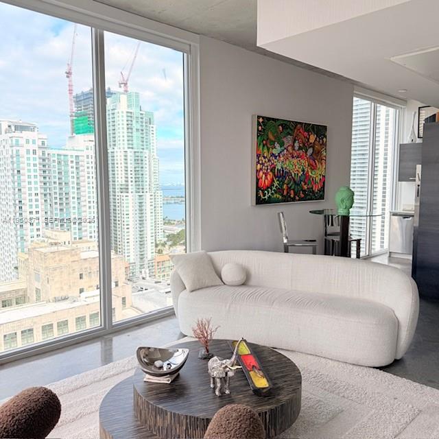 151 Southeast 1st Street, Unit 3010 Miami, FL 33131 - Photo 7 of 22 a living room with furniture and a large window