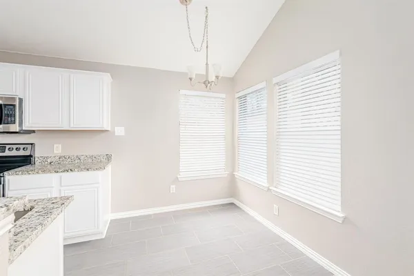 a view of a kitchen with an empty space and a window