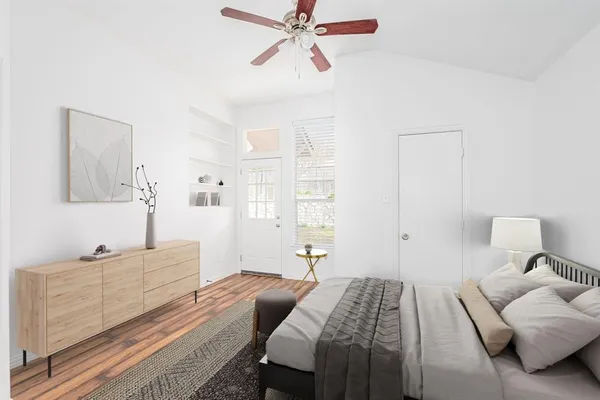 a bedroom with a bed and wooden floor