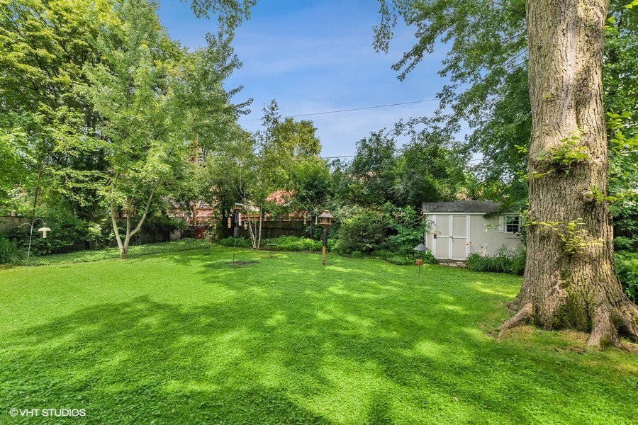 323 Wagner Road Northfield, IL 60093 - Photo 3 of 18 a view of a backyard with large trees