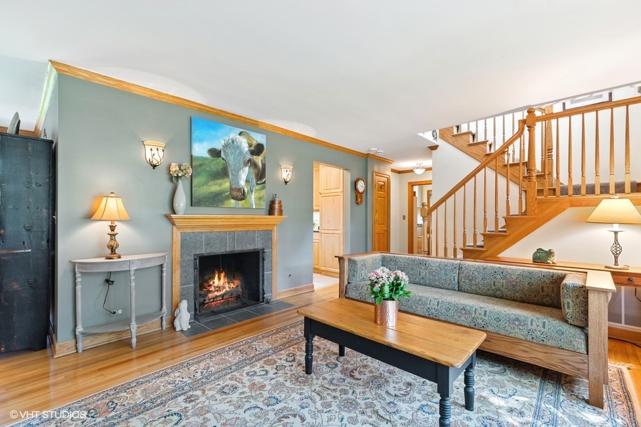 323 Wagner Road Northfield, IL 60093 - Photo 7 of 18 a living room with furniture and a fireplace