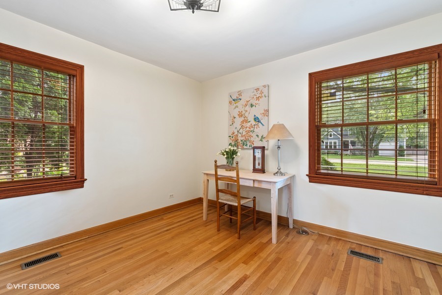 323 Wagner Road Northfield, IL 60093 - Photo 10 of 18 a dining room with wooden floor and a window