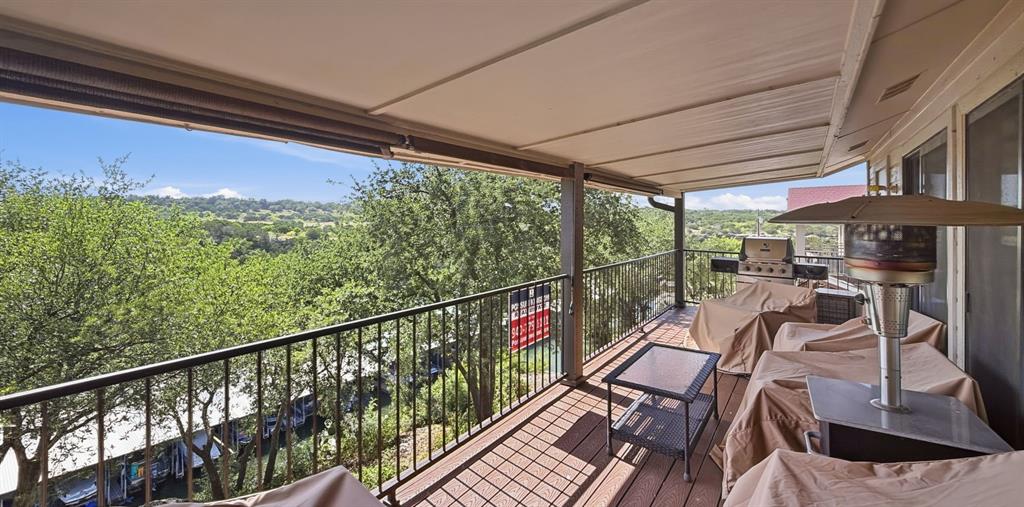 3037 Hells Gate Loop, Unit C208 Strawn, TX 76475 - Photo 7 of 24 a view of a chairs and table in the balcony