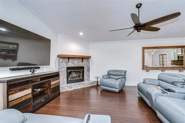 a spacious bedroom with a bed a dresser and a chandelier