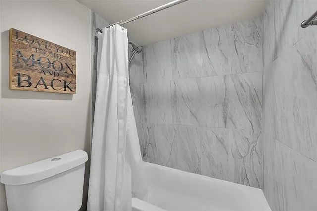 a bathroom with a shower and a toilet