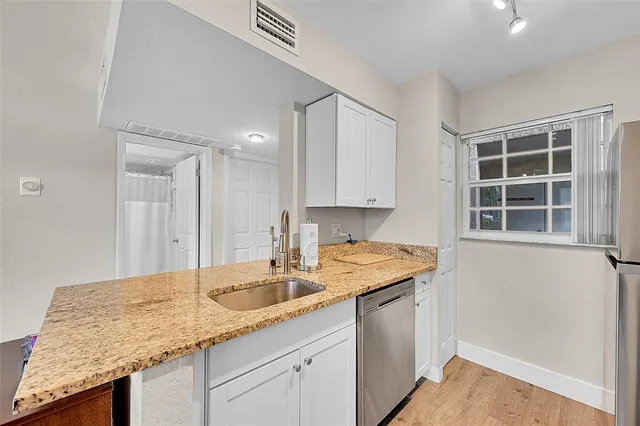 a kitchen with a sink and cabinets