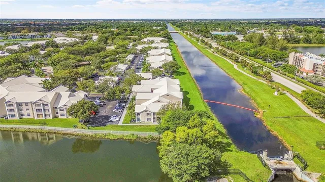 an aerial view of a house with a garden and lake view