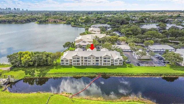 an aerial view of a house with a lake and a mountain view