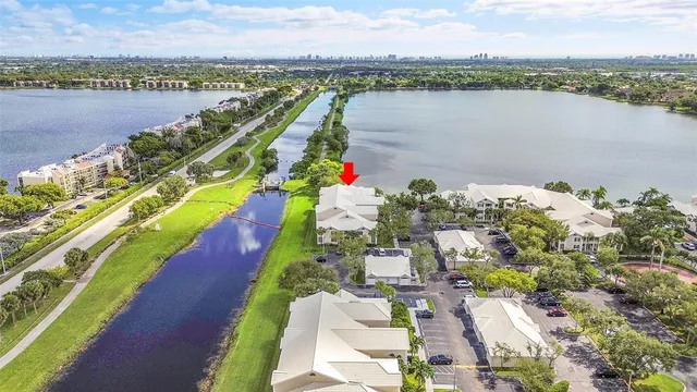 an aerial view of a house with a garden and lake view