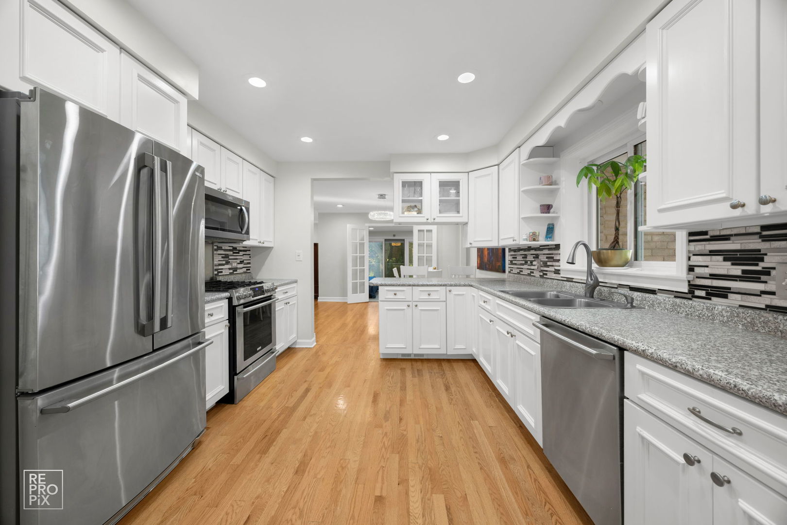6872 North Loron Avenue Chicago, IL 60646 - Photo 6 of 25 a large kitchen with stainless steel appliances sink a microwave and cabinets