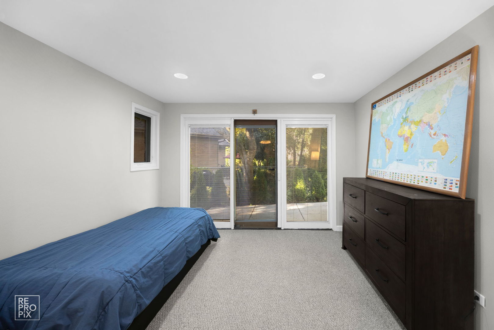 6872 North Loron Avenue Chicago, IL 60646 - Photo 9 of 25 a spacious bedroom with a large bed painting on the wall and a large window