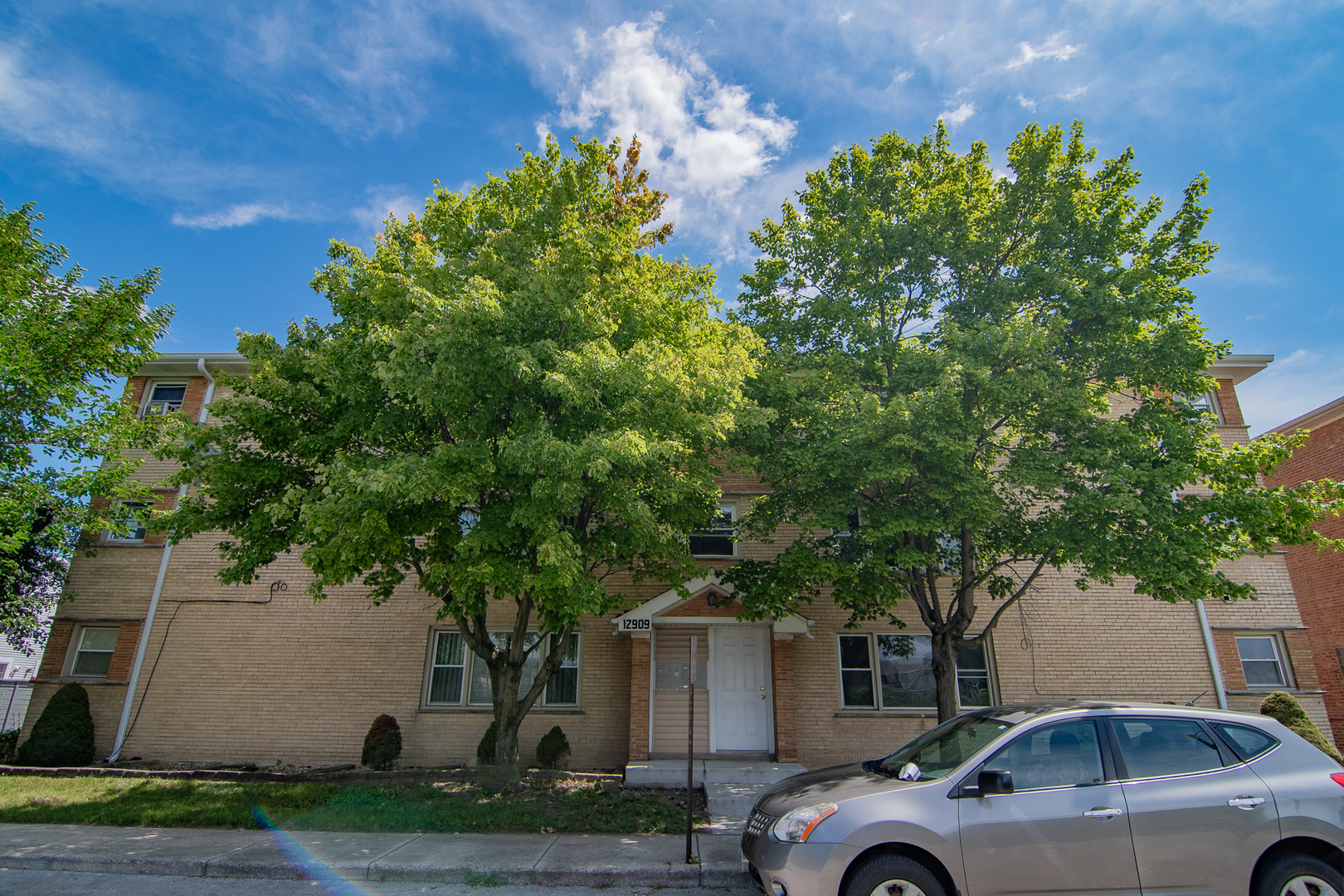 12909 Page Street Blue Island, IL 60406 - Photo 1 of 19 a front view of a house with a garden