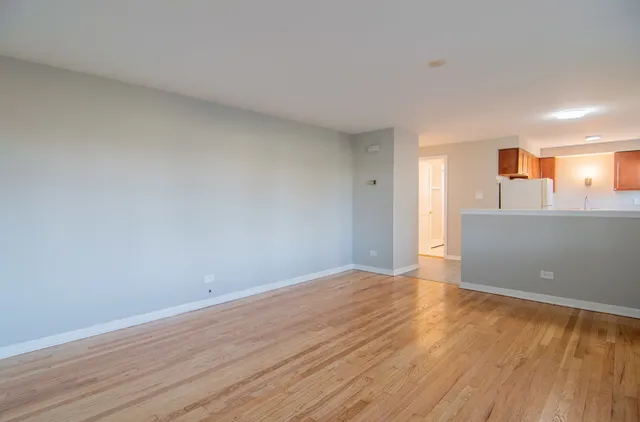 a view of a room with wooden floor