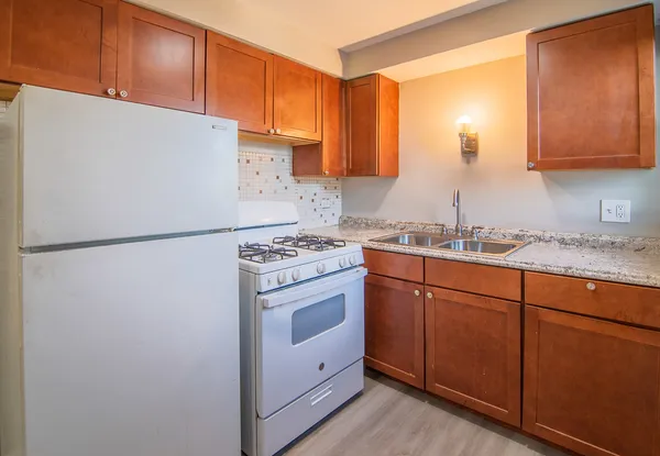 a kitchen with stainless steel appliances granite countertop a refrigerator sink and cabinets